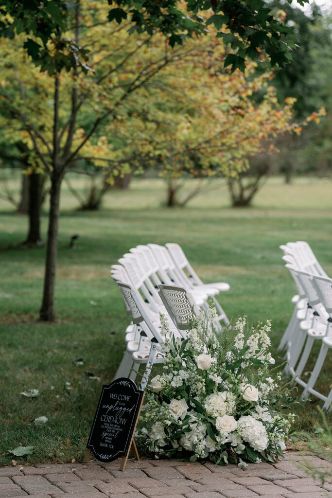 Ceremony seating area at Wellers Weddings surrounded by willow trees and historic garden landscape