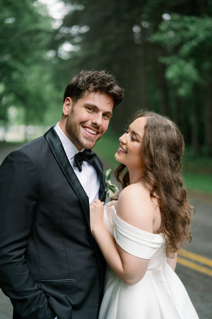 Bride and groom embracing during elegant outdoor wedding in Southwest Michigan, photographed by Raechel Marie Photo.