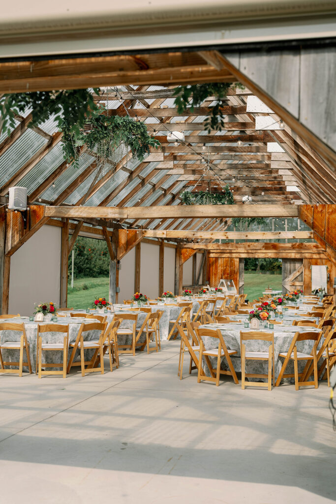 Orchard wedding reception at Nugent Orchards with wood beams and rustic barn inspired styling