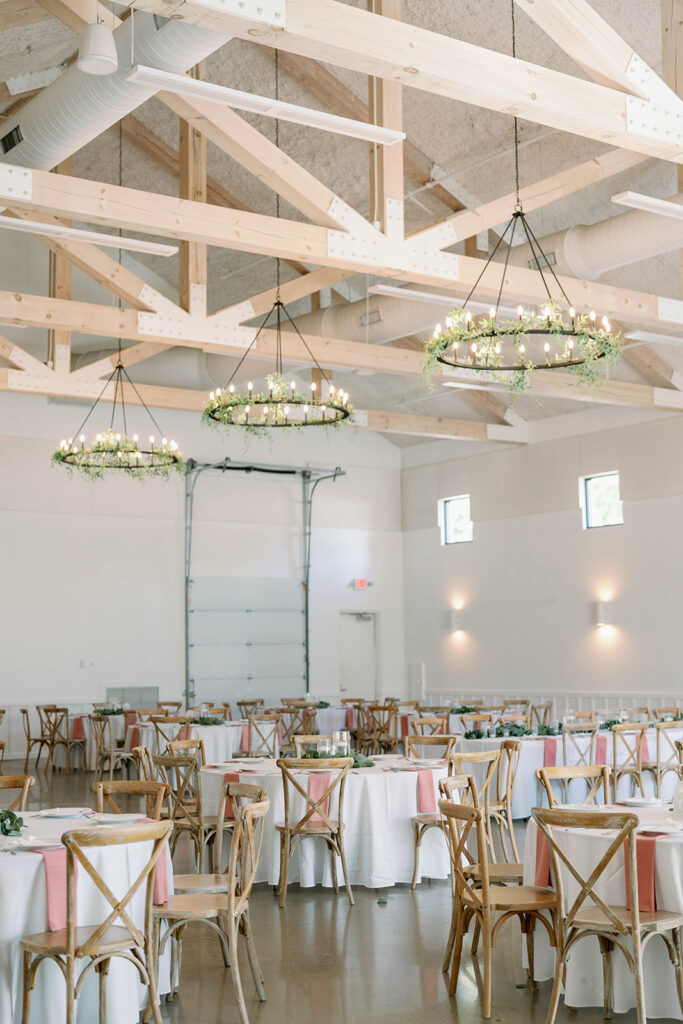 Reception room at Ivy House with greenery chandeliers and white modern decor in Saugatuck Michigan