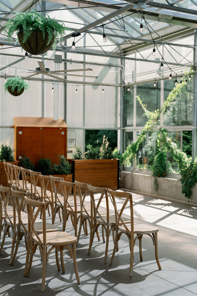 Greenhouse ceremony space at Ivy House in Saugatuck filled with greenery and natural light for a garden inspired wedding