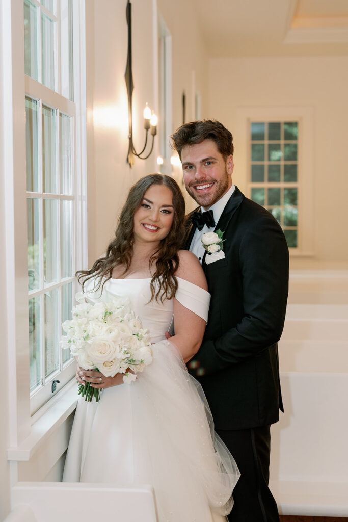 Couple standing inside The Morris Estate chapel with soft natural light and elegant details