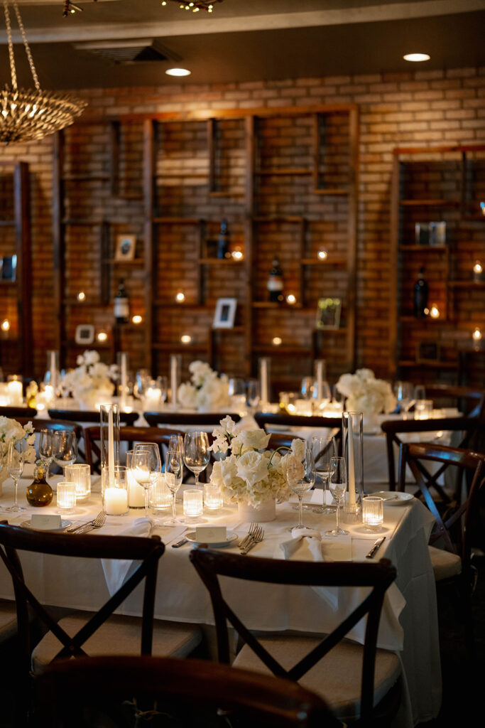Candlelit reception table setting at Cafe Cortina with Italian inspired ambiance and romantic lighting
