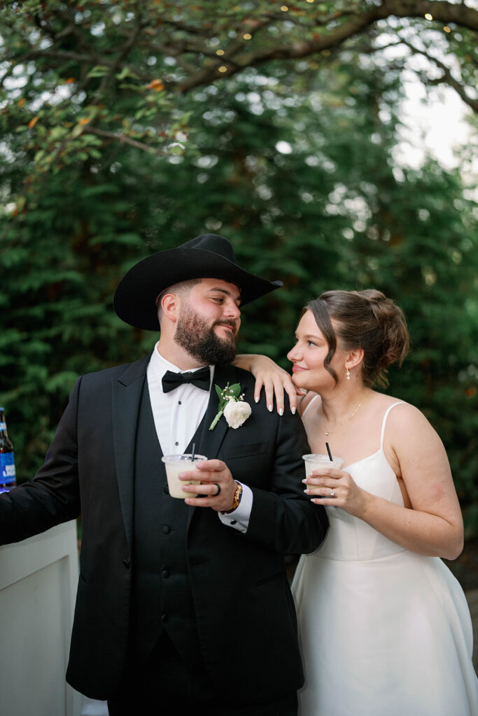 Couple celebrating at Cafe Cortina with lush outdoor greenery during an intimate Michigan wedding