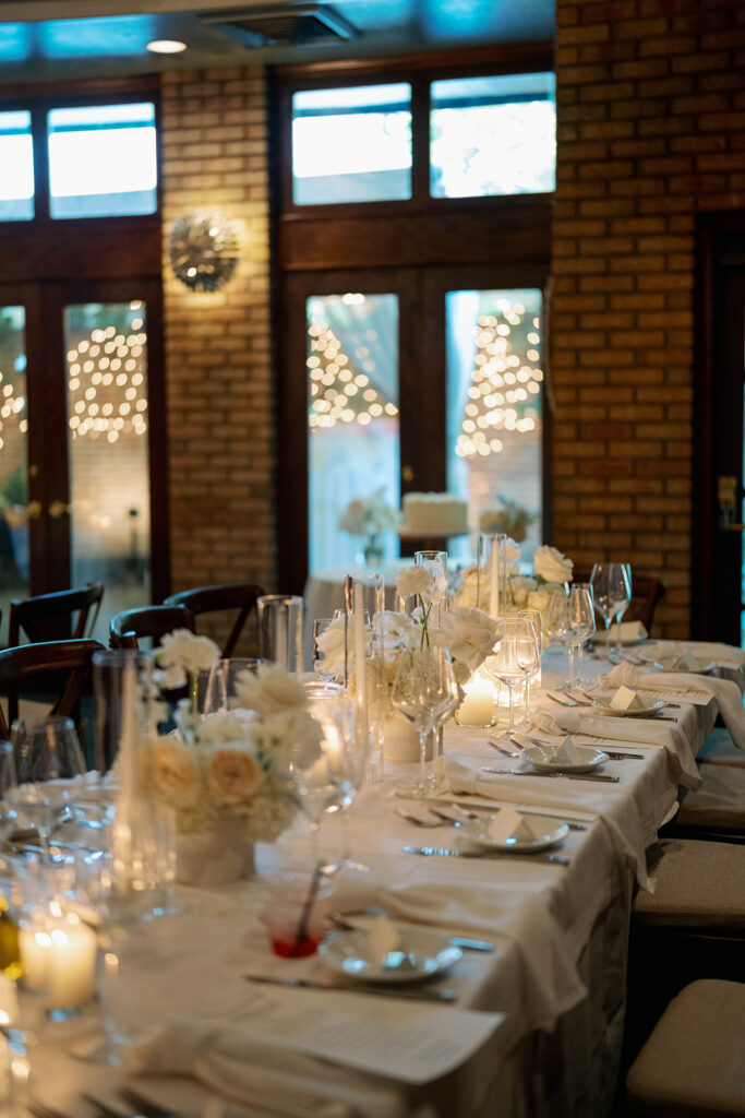 Cafe Cortina reception space with long candlelit tables inside a warm Italian inspired wedding venue