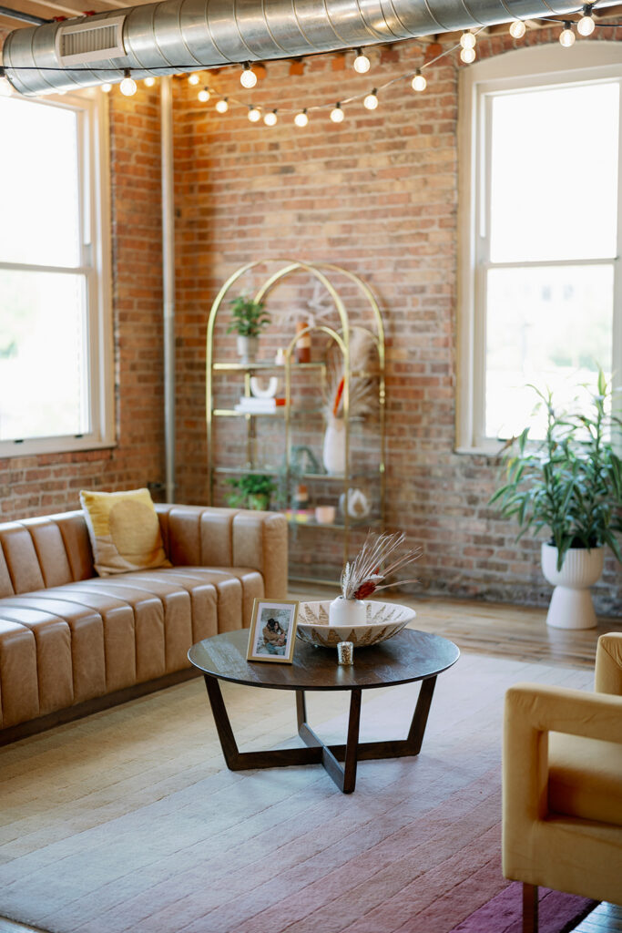 Record Box Loft lounge area with exposed brick and cozy industrial seating inside this Southwest Michigan wedding venue