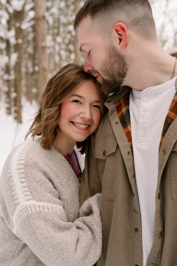 Close up portrait of a couple embracing during a winter couples session in Southwest Michigan