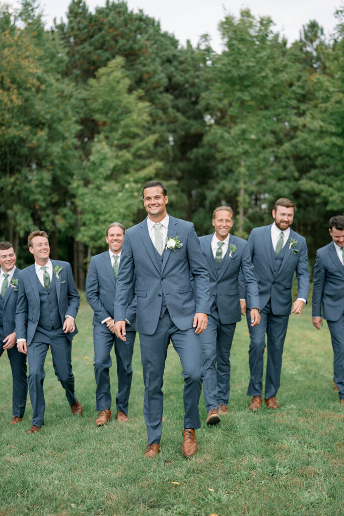 groomsmen posing together at Nugent Orchards wedding in Michigan