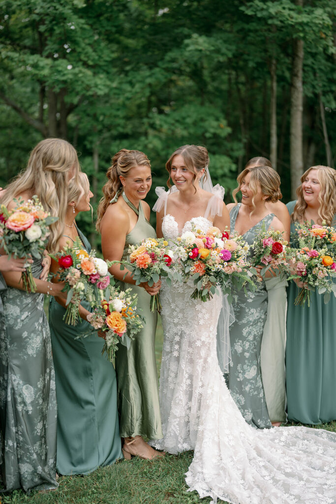 bridesmaids walking together in wooded area at Nugent Orchards wedding venue