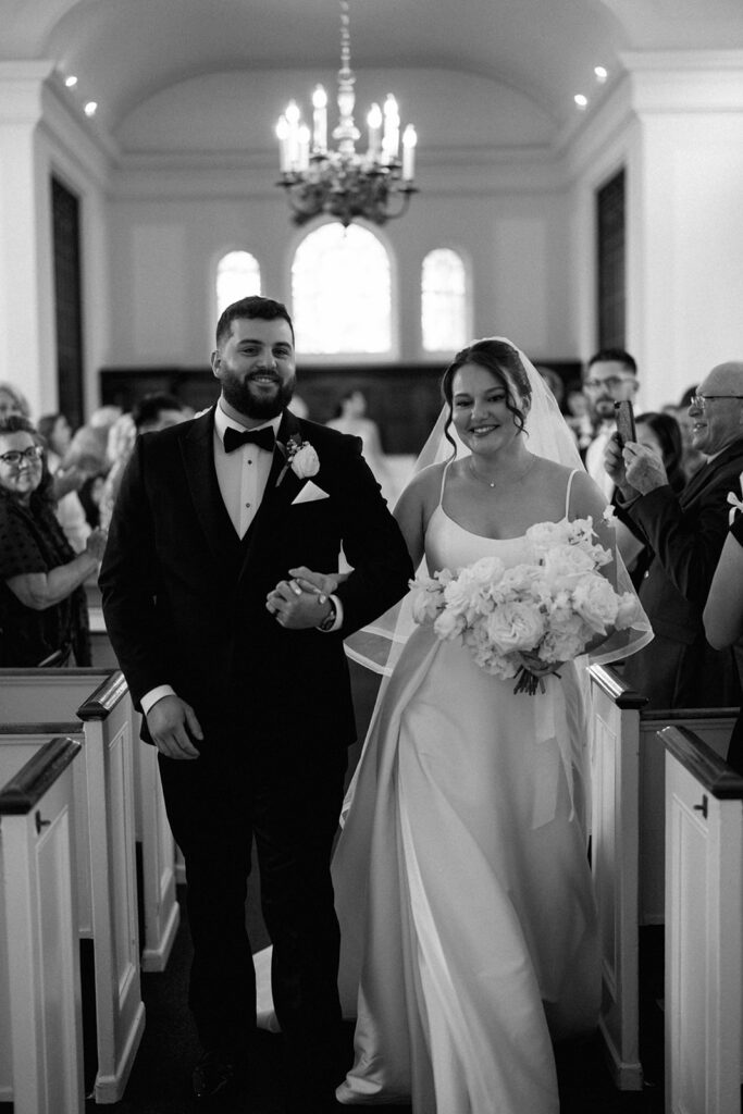 bride and groom walking down aisle just married Greenfield Village Michigan