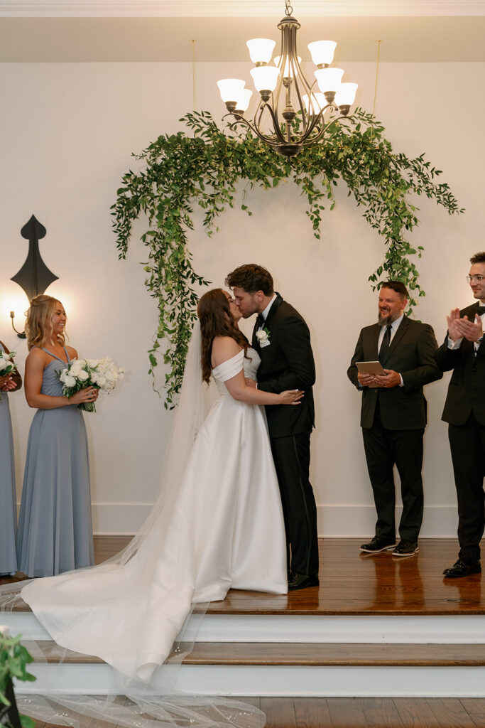 bride and groom kissing insidechapel Morris Estate wedding Michigan