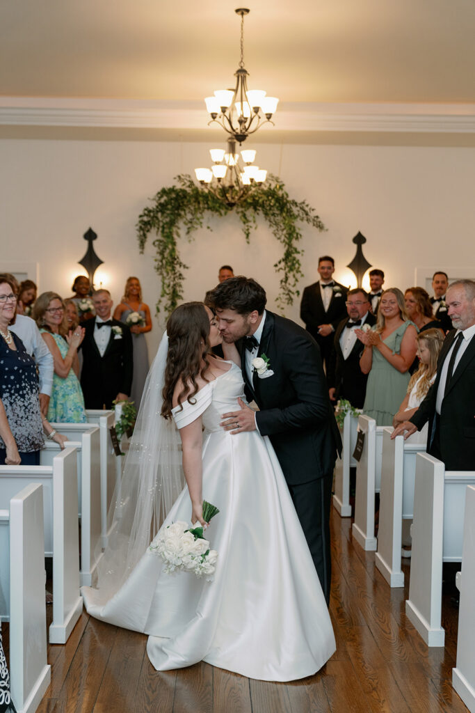 bride and groom kissing in Morris Estate WEdding chapel ceremony