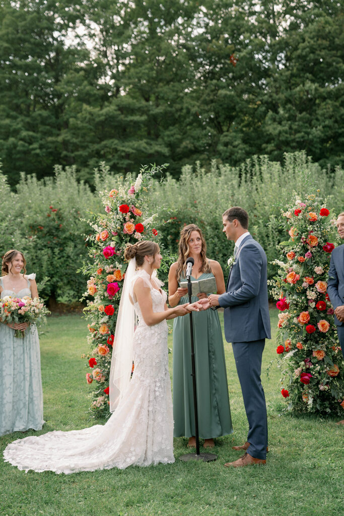 outdoor orchard ceremony at Nugent Orchards wedding in Frankfort Michigan
