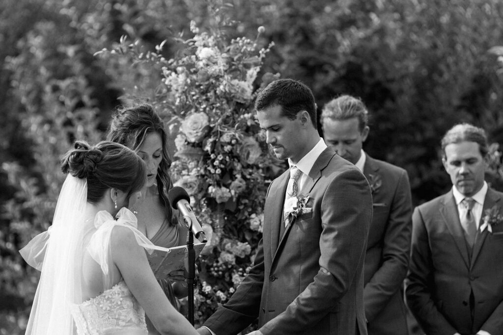 black and white photo of bride and groom during ceremony at orchard wedding in Michigan