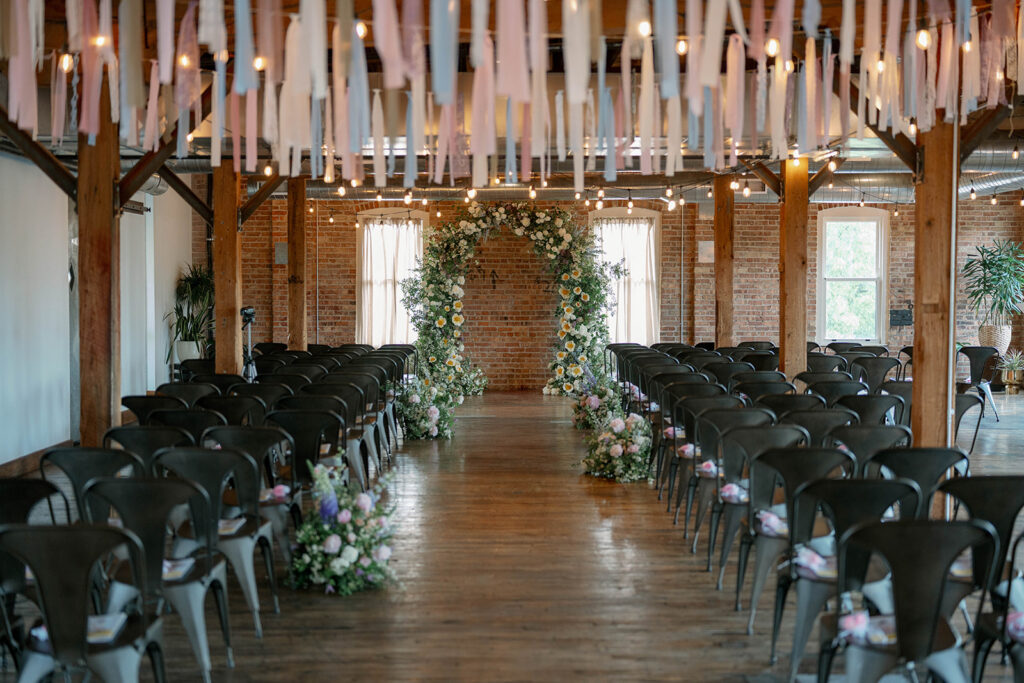 ceremony aisle with floral installation Record Box Loft Michigan wedding