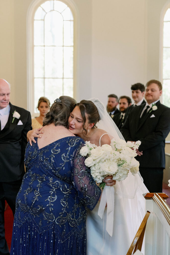 bride and mom hugging family after ceremony Greenfield Village Dearborn