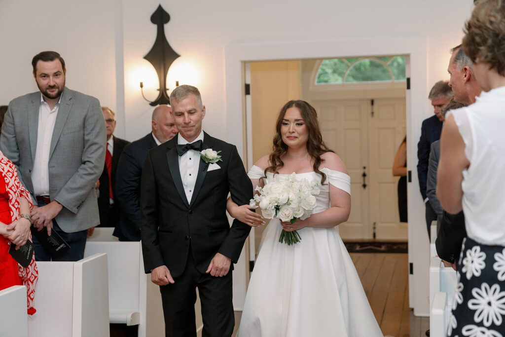 Emotional moment of bride and her father walking down the aisle