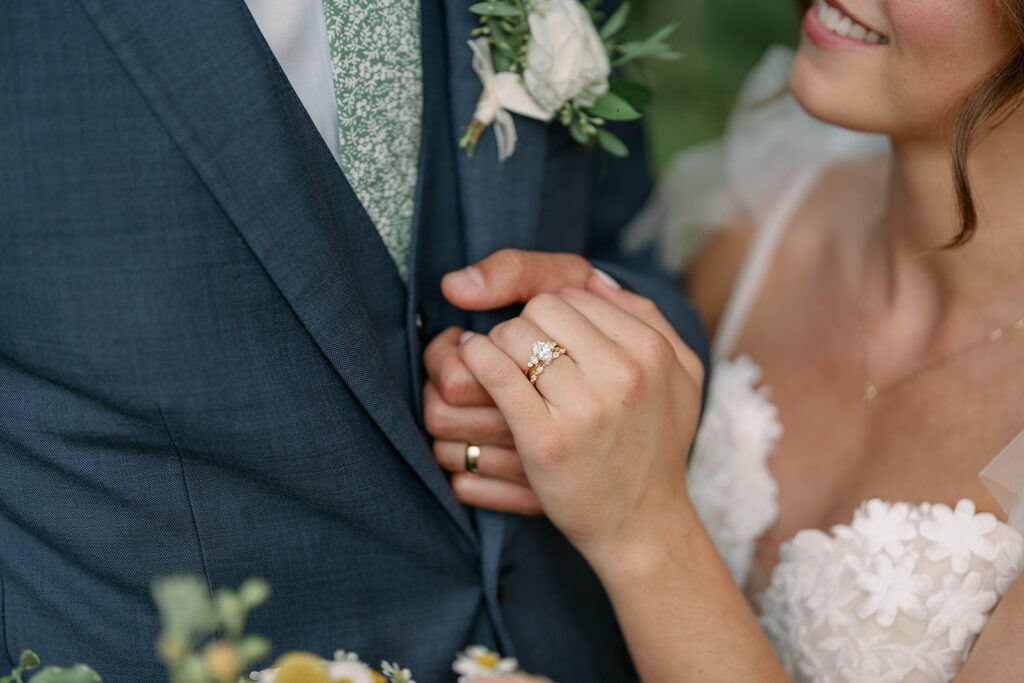 close up of bride and groom wedding rings at Nugent Orchards wedding in Michigan