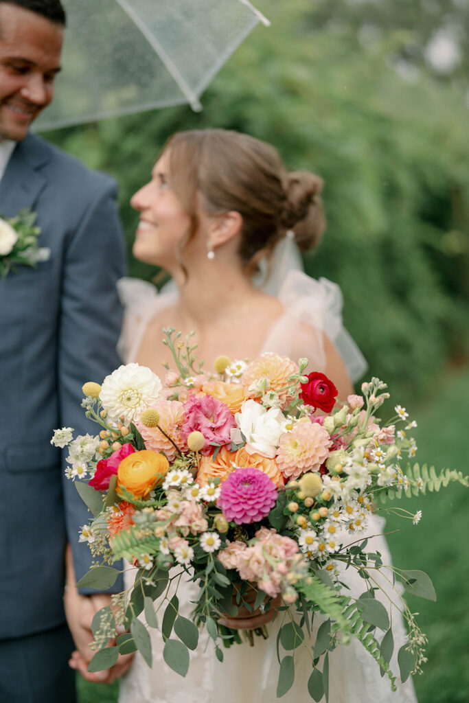 colorful summer wedding bouquet with daisies and roses at Nugent Orchards