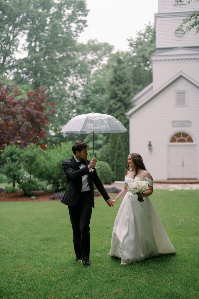 bride laughing with groom during rainy wedding portrait Michigan