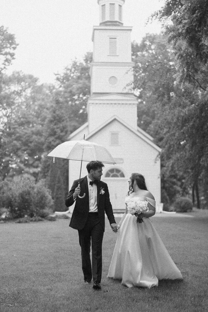 bride laughing with groom during rainy wedding portrait Michigan