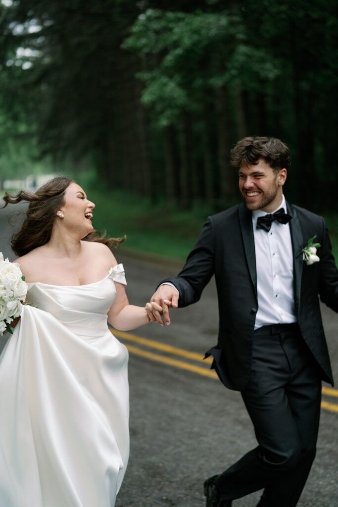 romantic couple running together on rainy wedding day Niles Michigan