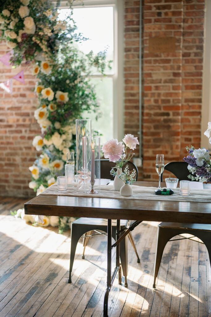 elegant reception table with candles and glassware Record Box Loft