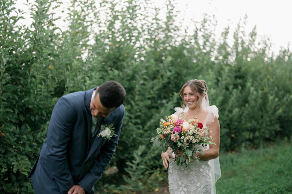 groom reacting emotionally during first look at Nugent Orchards wedding in Michigan