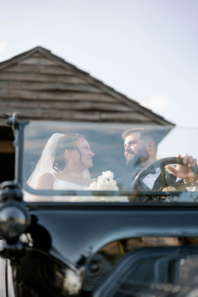 bride and groom in vintage car at Greenfield Village Dearborn Michigan wedding