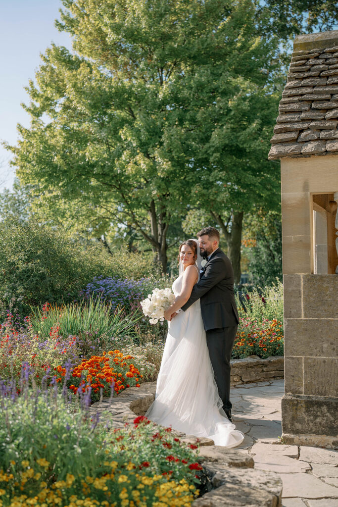 bride and groom in flower garden Dearborn Michigan wedding portraits