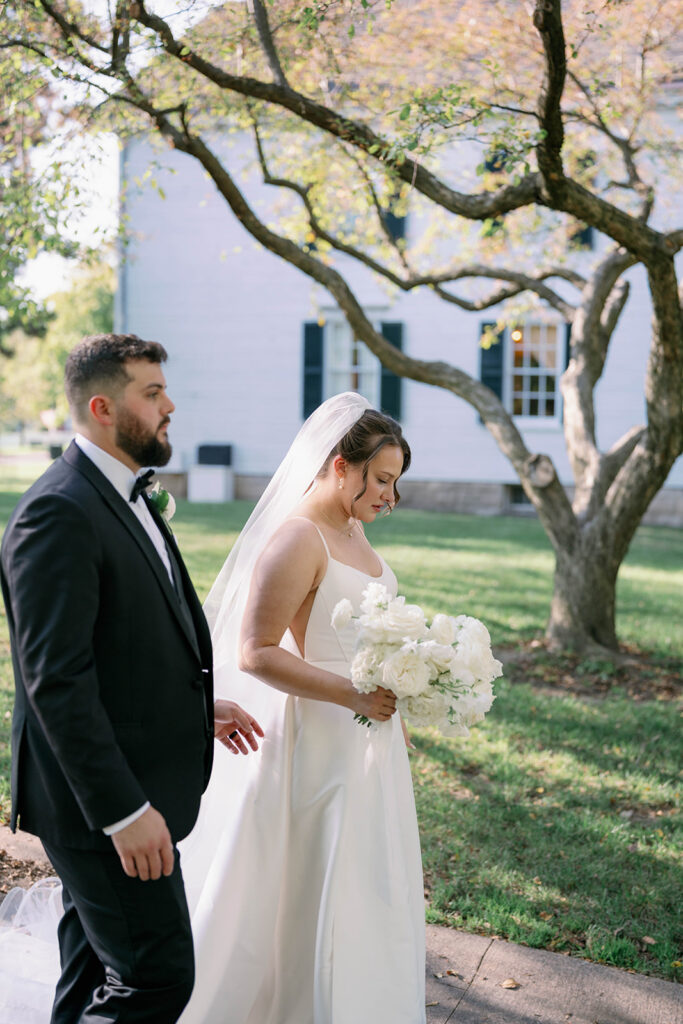 bride and groom walking through garden Greenfield Village wedding Michigan