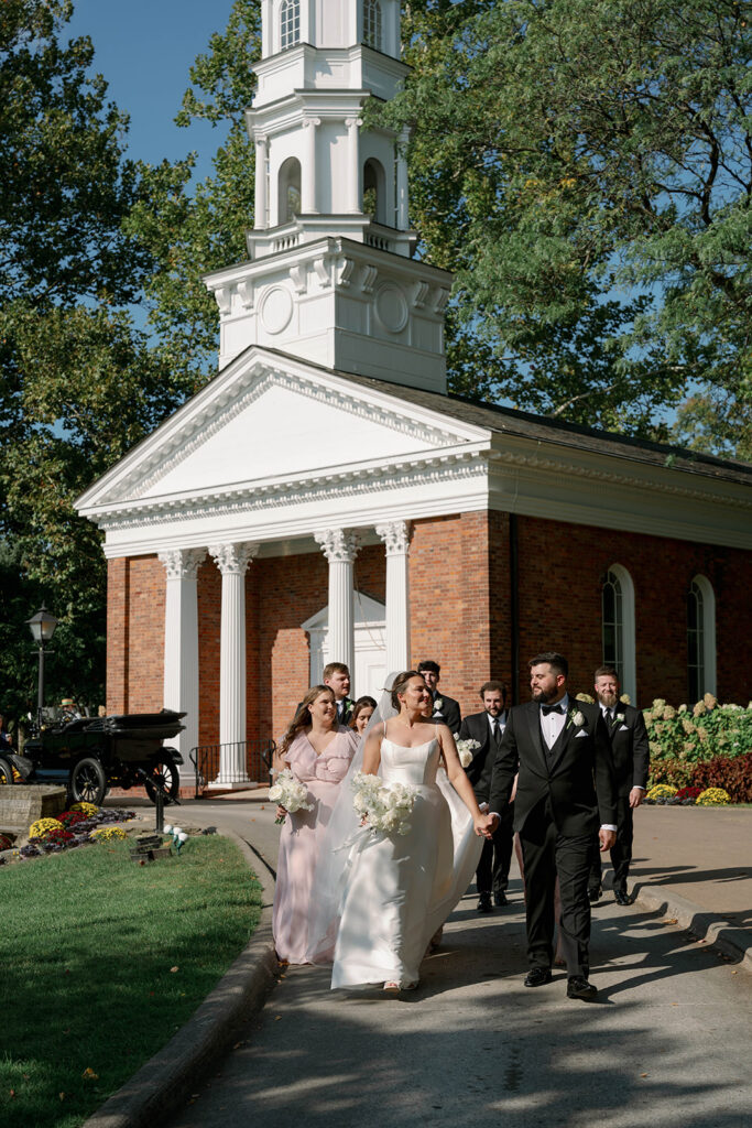 wedding party walking outside chapel Dearborn Michigan