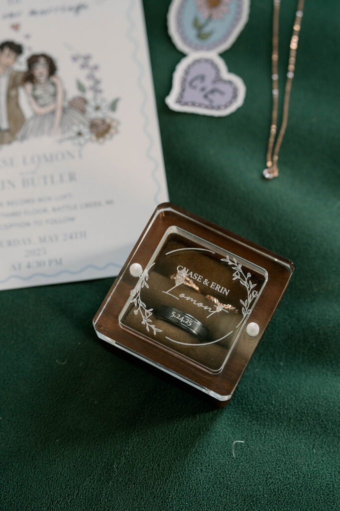wedding invitation and ring detail flat lay Record Box Loft Michigan
