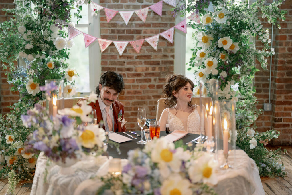 bride and groom seated at sweetheart table wedding Michigan