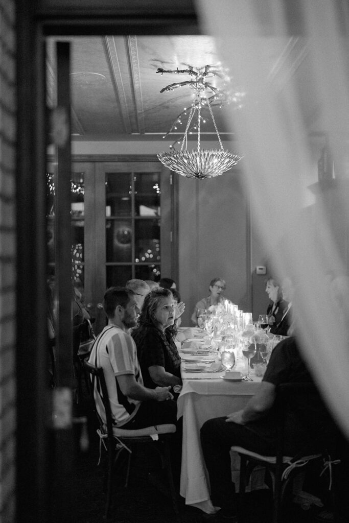 wedding guests seated at long dinner table during reception at Cafe Cortina in Dearborn Michigan