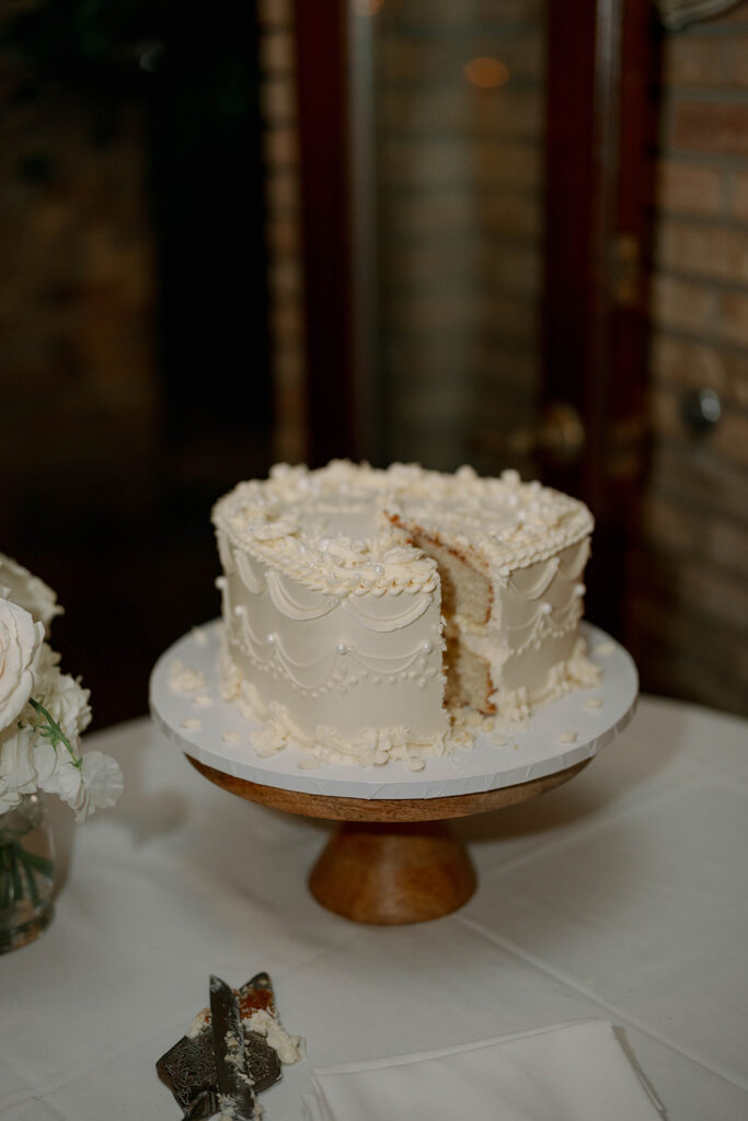 white wedding cake with floral detailing at Cafe Cortina reception in Dearborn Michigan