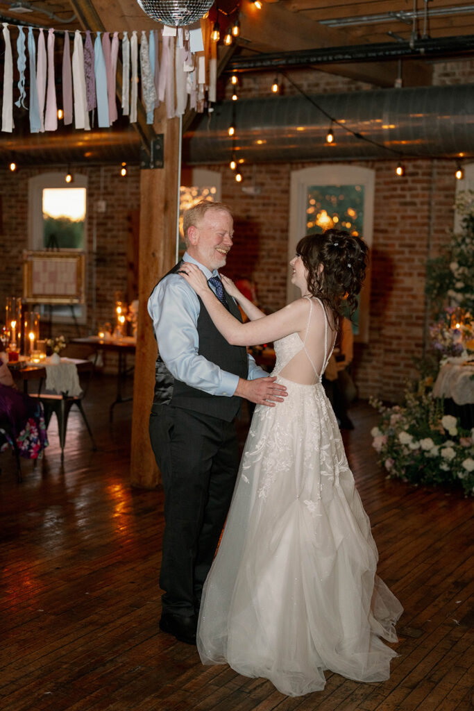 father and bride dancing under string lights wedding Michigan
