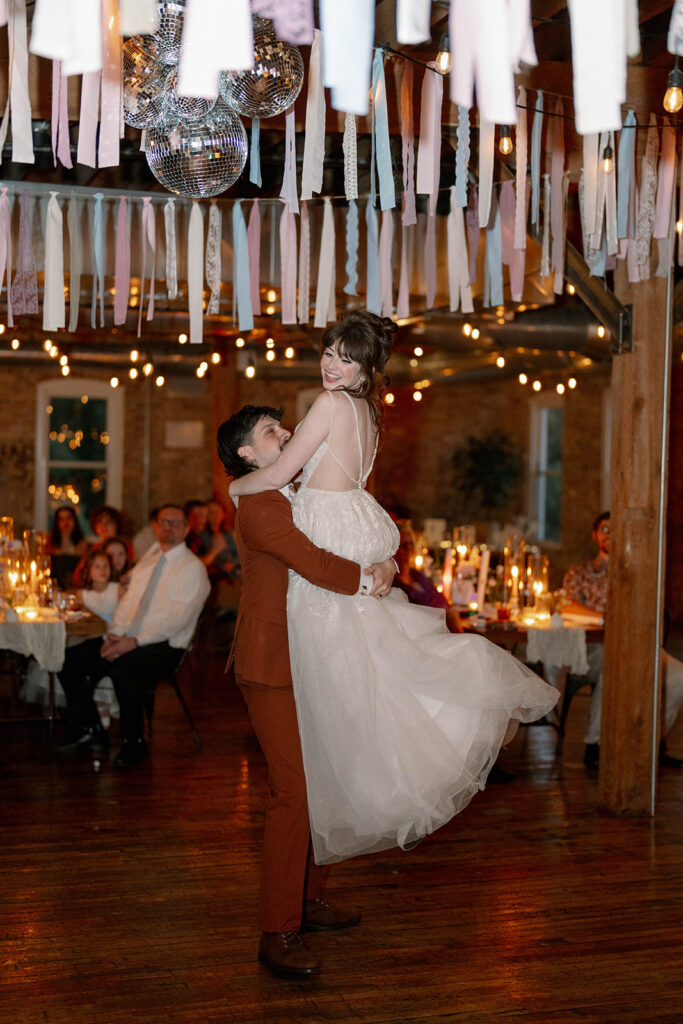 bride lifted during reception dancing Record Box Loft Michigan