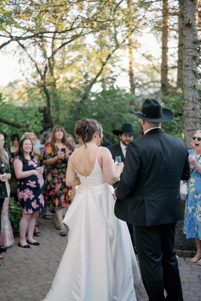 wedding guests watching speech during outdoor reception at Cafe Cortina in Dearborn Michigan