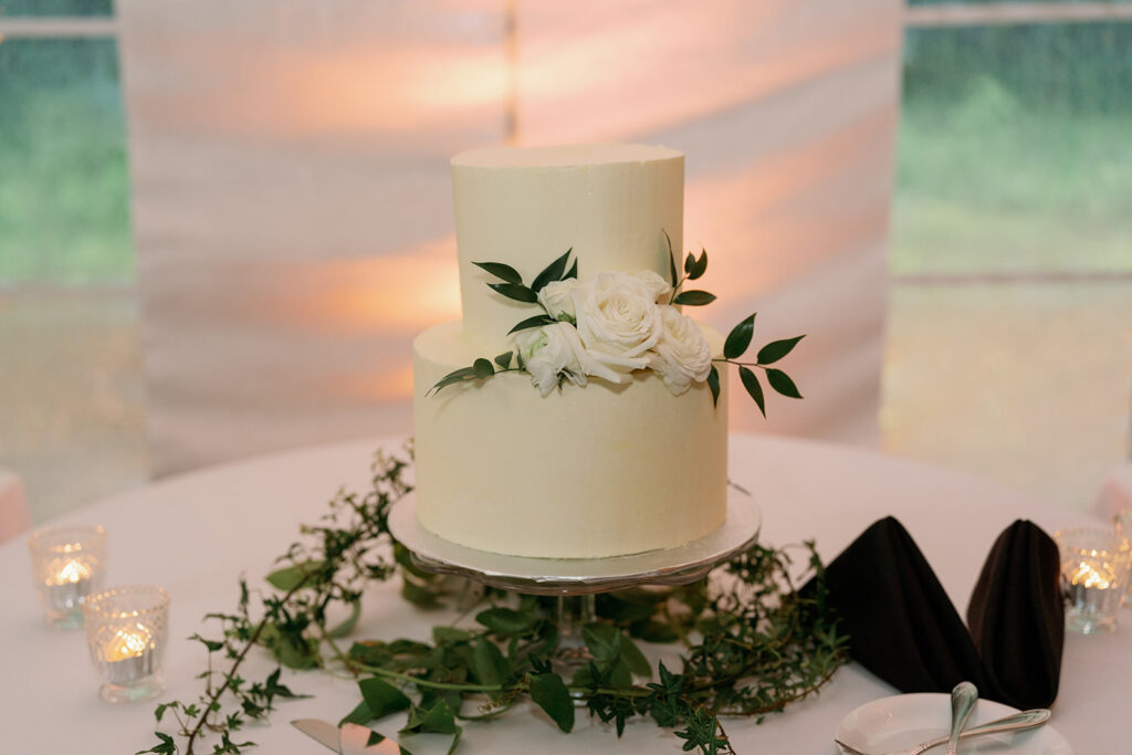 wedding cake with greenery detail at reception in Michigan