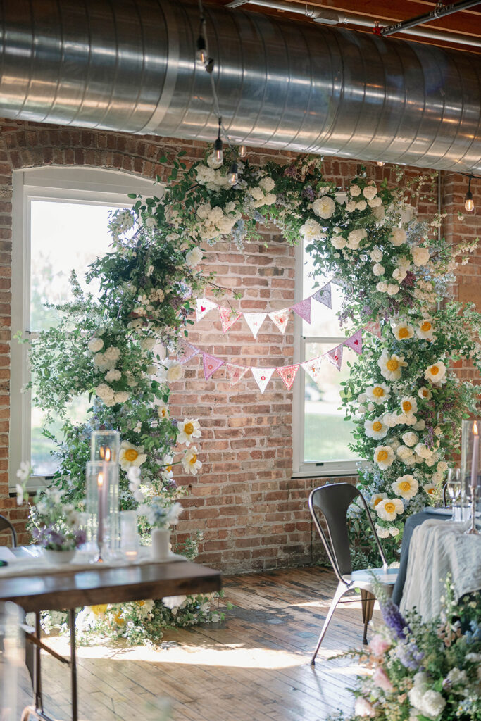 ceremony space with floral arch Record Box Loft Battle Creek